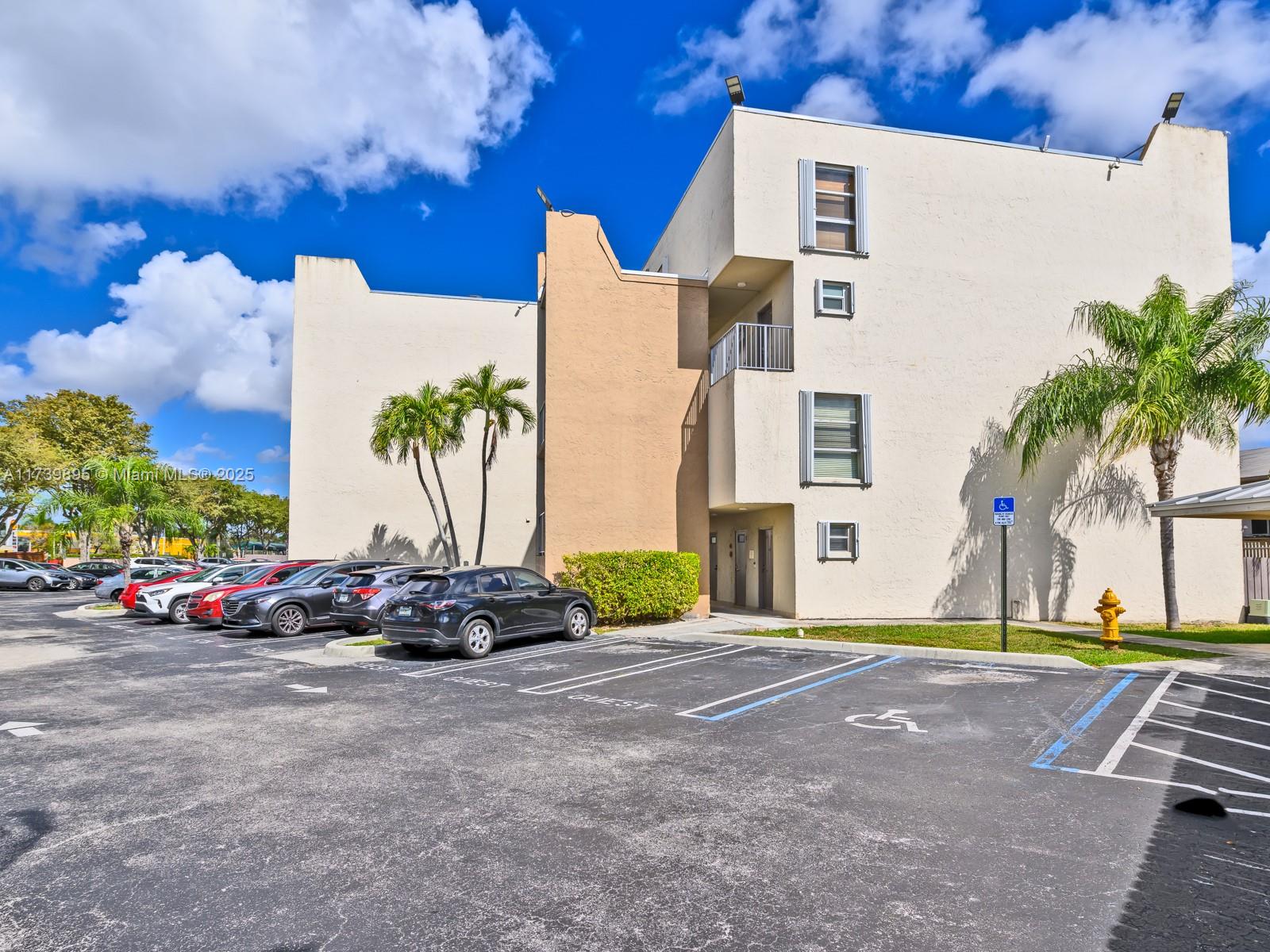 10900 Southwest 104th Street, Unit 114 Miami, FL 33176 - Photo 20 of 31 a front view of multi story residential apartment building with yard