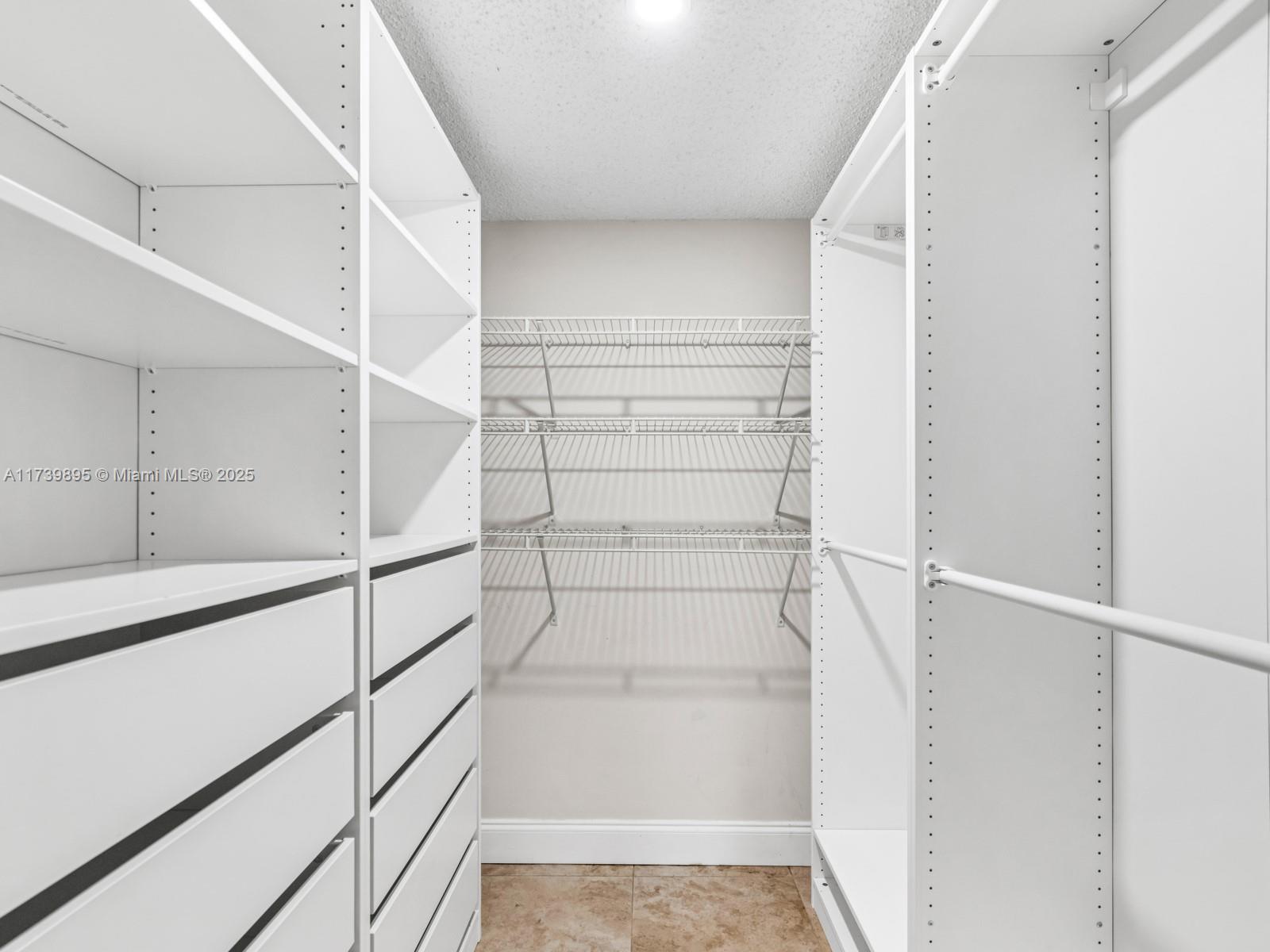 10900 Southwest 104th Street, Unit 114 Miami, FL 33176 - Photo 10 of 31 a view of walk in closet with empty racks