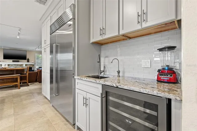 a kitchen with stainless steel appliances granite countertop a refrigerator and a sink