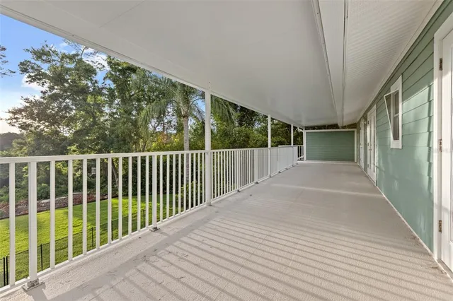 a balcony with trees in front of it
