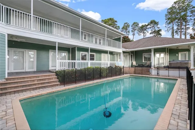 a swimming pool with outdoor seating and yard