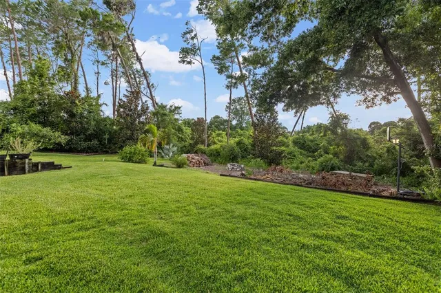a view of a house with a yard and sitting area