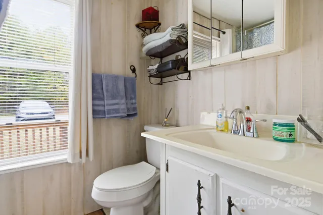 a kitchen with a sink cabinets and wooden floor