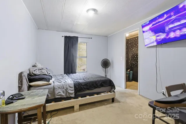 a bedroom with a bed and a chair