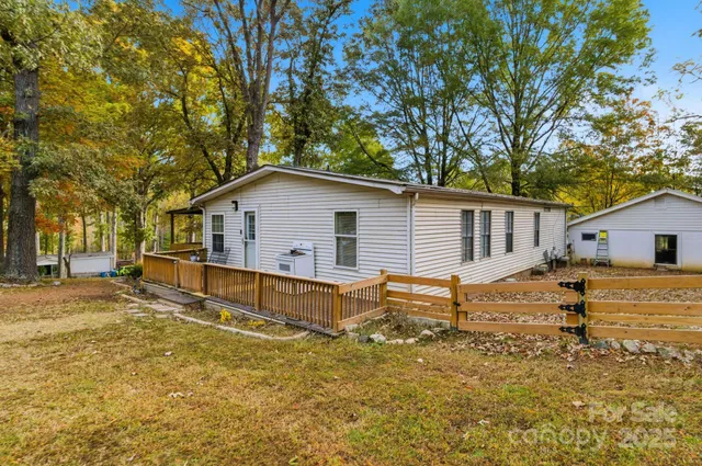 a view of a house with a yard and tree