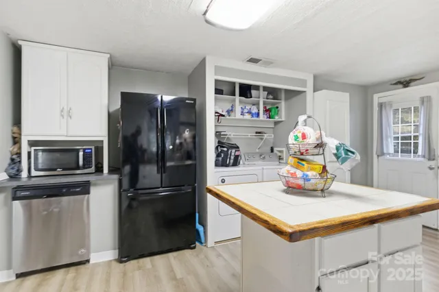 a kitchen with a refrigerator a microwave a stove and a sink