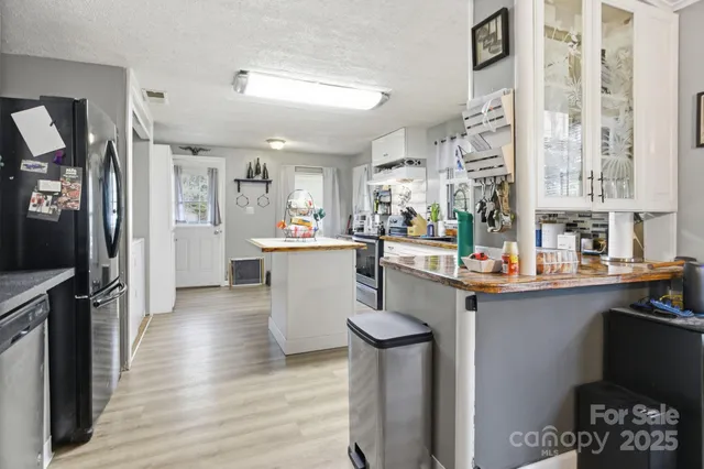 a kitchen with sink refrigerator and cabinets