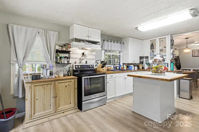 a kitchen with stainless steel appliances a stove a sink dishwasher and cabinets