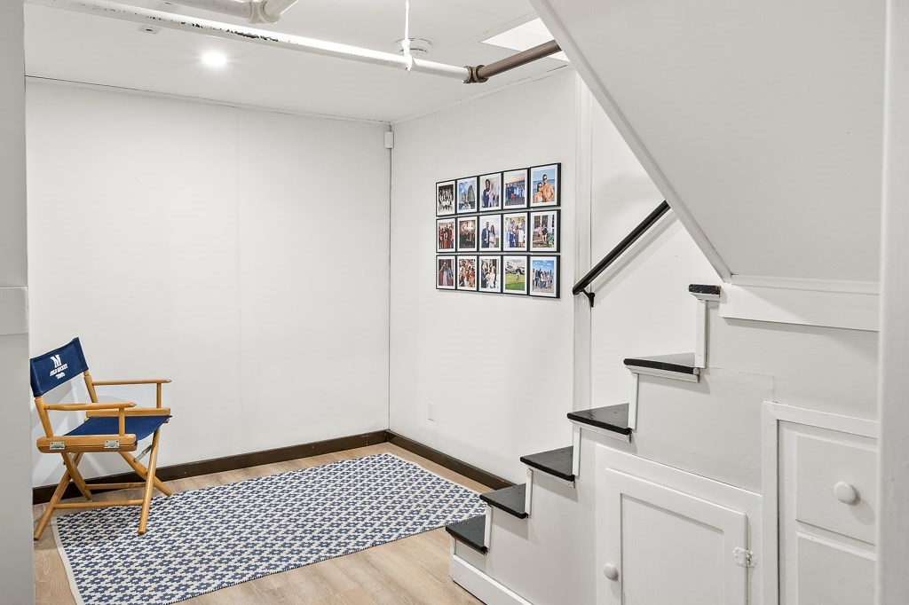 1 Bancroft Road Wellesley, MA 02481 - Photo 17 of 20 a view of a livingroom with wooden floor and white walls