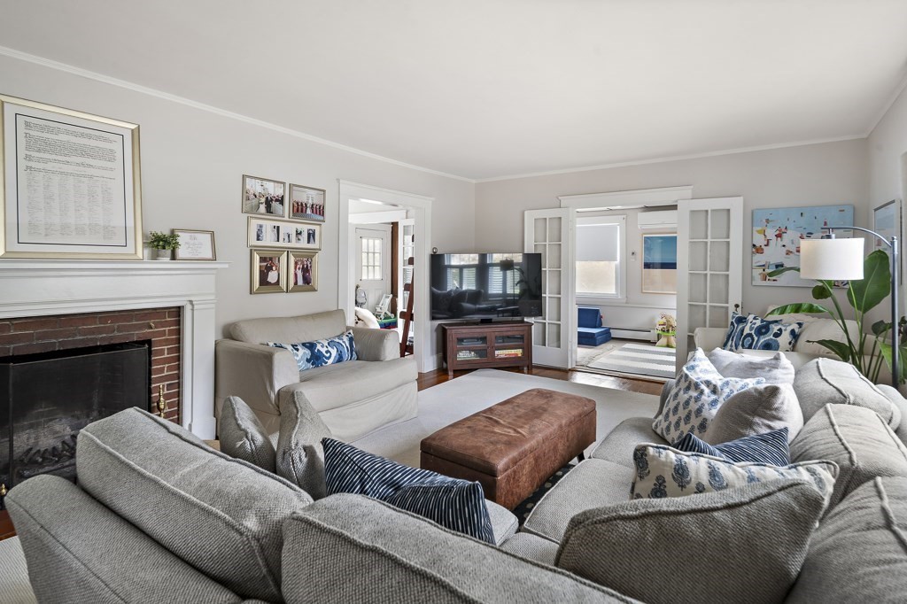 1 Bancroft Road Wellesley, MA 02481 - Photo 3 of 20 a living room with furniture and a fireplace
