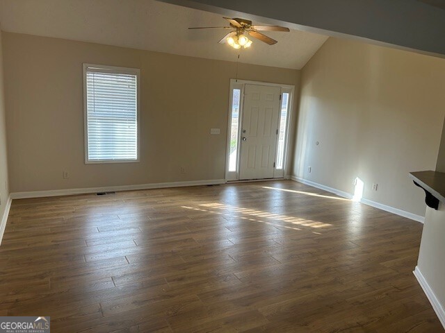 341 Baker Street Monroe, GA 30655 - Photo 6 of 10 an empty room with wooden floor and windows