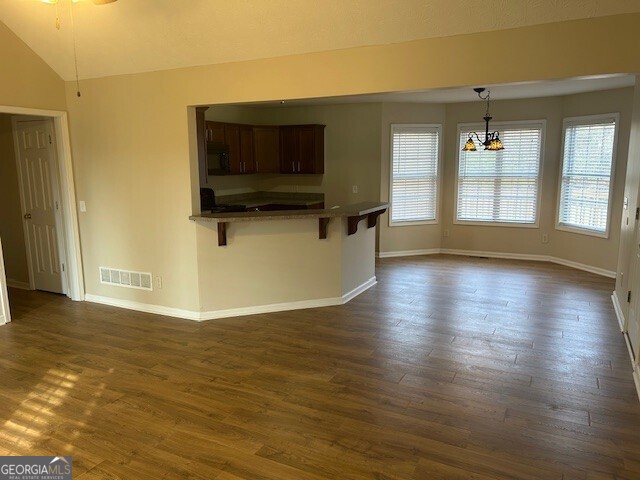341 Baker Street Monroe, GA 30655 - Photo 7 of 10 a view of a livingroom with wooden floor and a flat screen tv