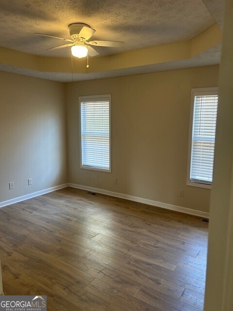 341 Baker Street Monroe, GA 30655 - Photo 8 of 10 a view of empty room with wooden floor and fan