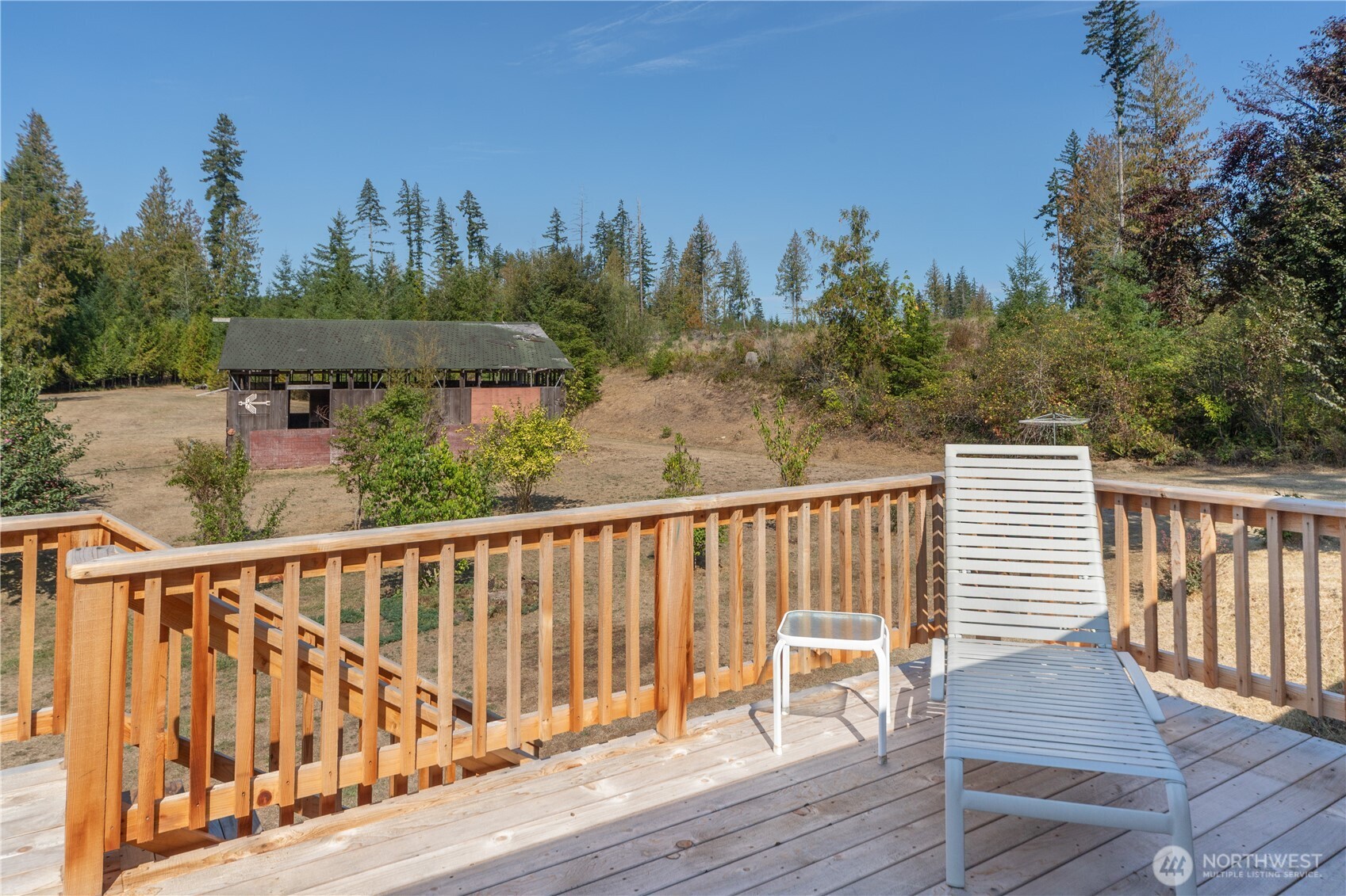 2035 Egg And I Road Chimacum, WA 98325 - Photo 26 of 40 a view of a deck with wooden floor and fence next to a yard
