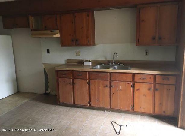145 Tracy Brewer Road Meshoppen, PA 18630 - Photo 6 of 20 a kitchen with granite countertop a sink cabinets and stainless steel appliances