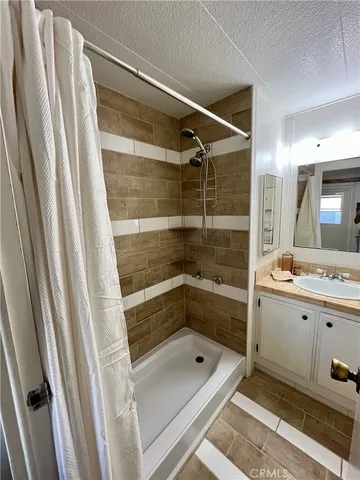 a bathroom with a shower and a sink