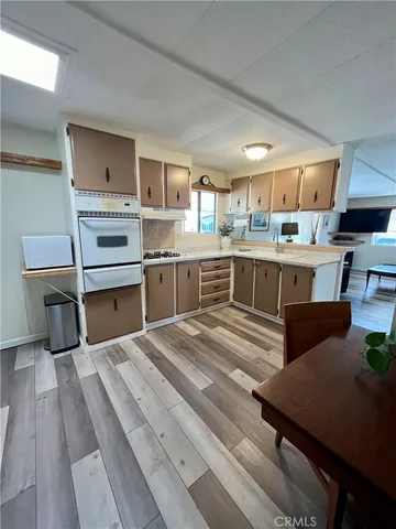 a kitchen with a stove a sink dishwasher and a refrigerator