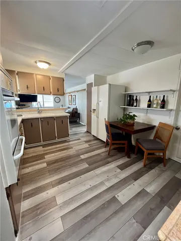 a living room with stainless steel appliances kitchen island granite countertop furniture and a kitchen view