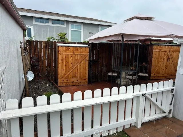 a view of wooden house with a wooden fence