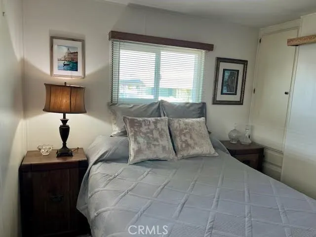 a bedroom with a bed and a night stand