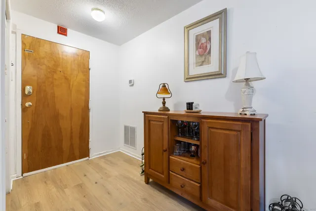 a bed room with a bed and a mirror