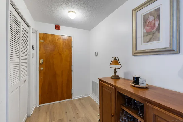 a view of a workspace with furniture and wooden floor