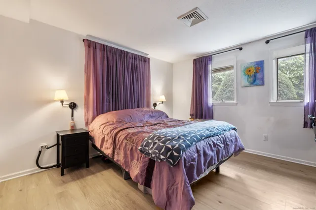 a bedroom with a bed and window