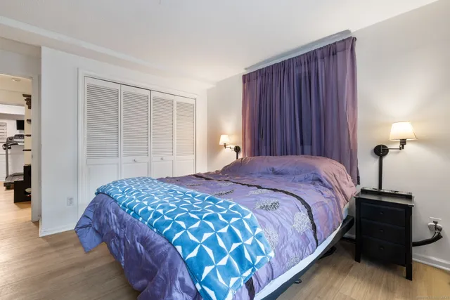 a bedroom with a bed and a night stand