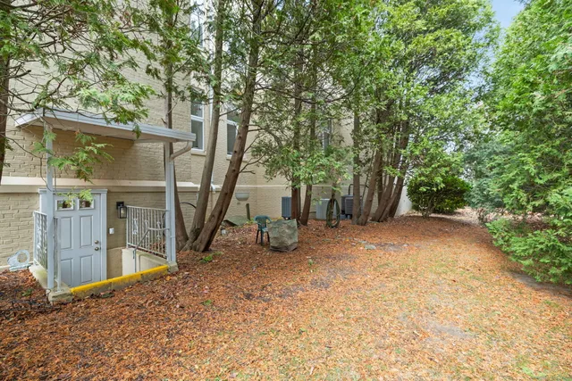 a view of a house with a tree in the background