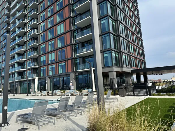a view of a swimming pool with outdoor seating