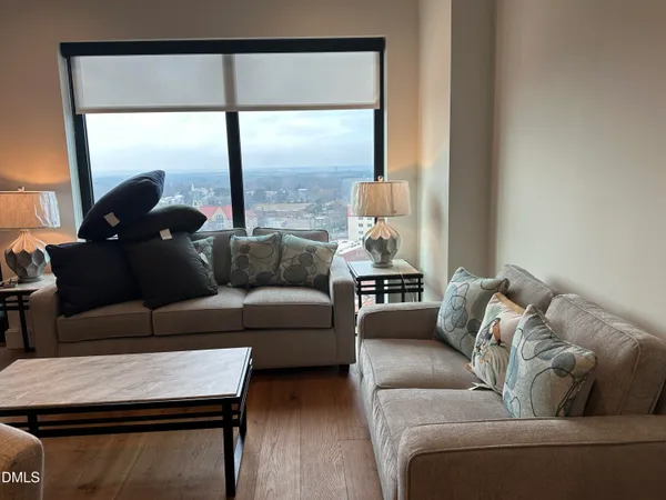 a living room with furniture and a large window
