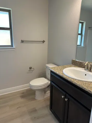 a kitchen with granite countertop a stove and a sink