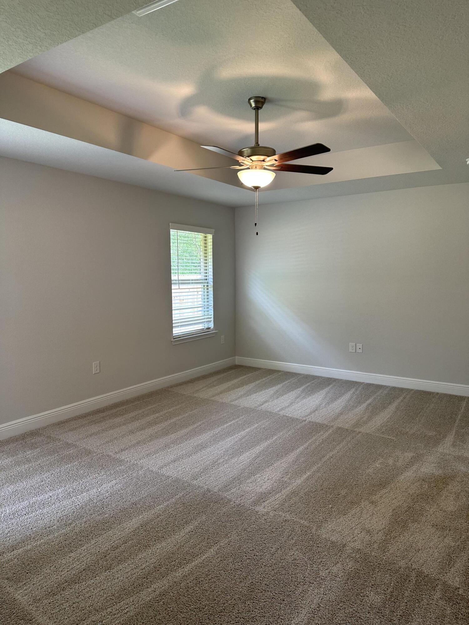 186 Ridgeway Circle Crestview, FL 32536 - Photo 18 of 23 an empty room with windows and ceiling fan