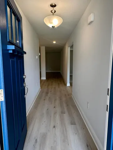 a view of a room with wooden floor