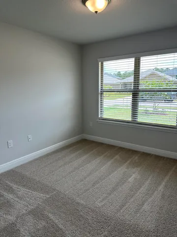 a bathroom with a granite countertop sink toilet and mirror