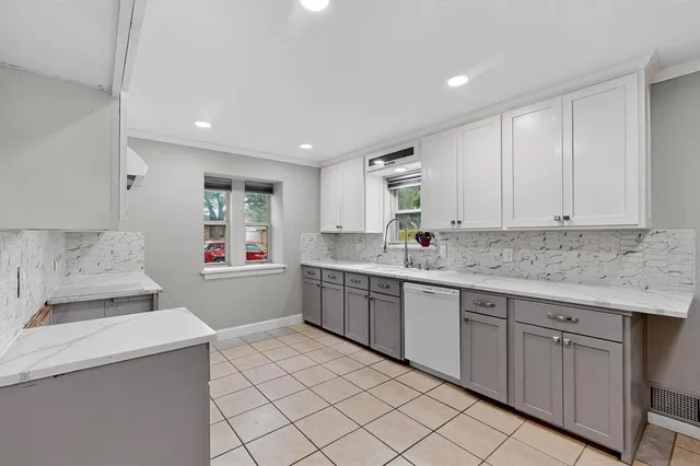 a kitchen with sink cabinets and window
