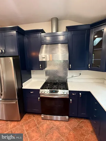 a kitchen with a stove and a refrigerator