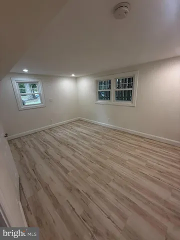 a view of a small space with wooden floor and staircase