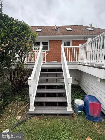a view of a deck with two chairs and a yard