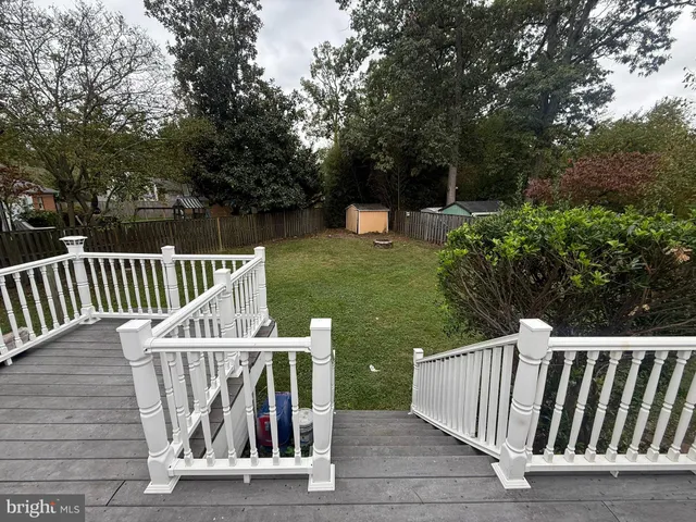 a view of outdoor space with deck and trees