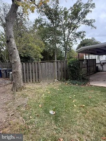 a backyard of a house with a swing and slide