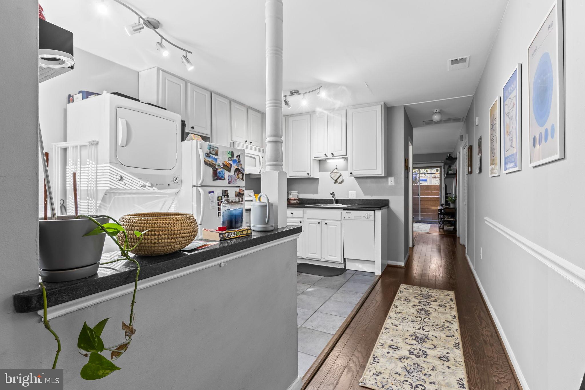 1729 Newton Street Northwest Washington, DC 20010 - Photo 33 of 45 a kitchen with sink a counter and cabinets