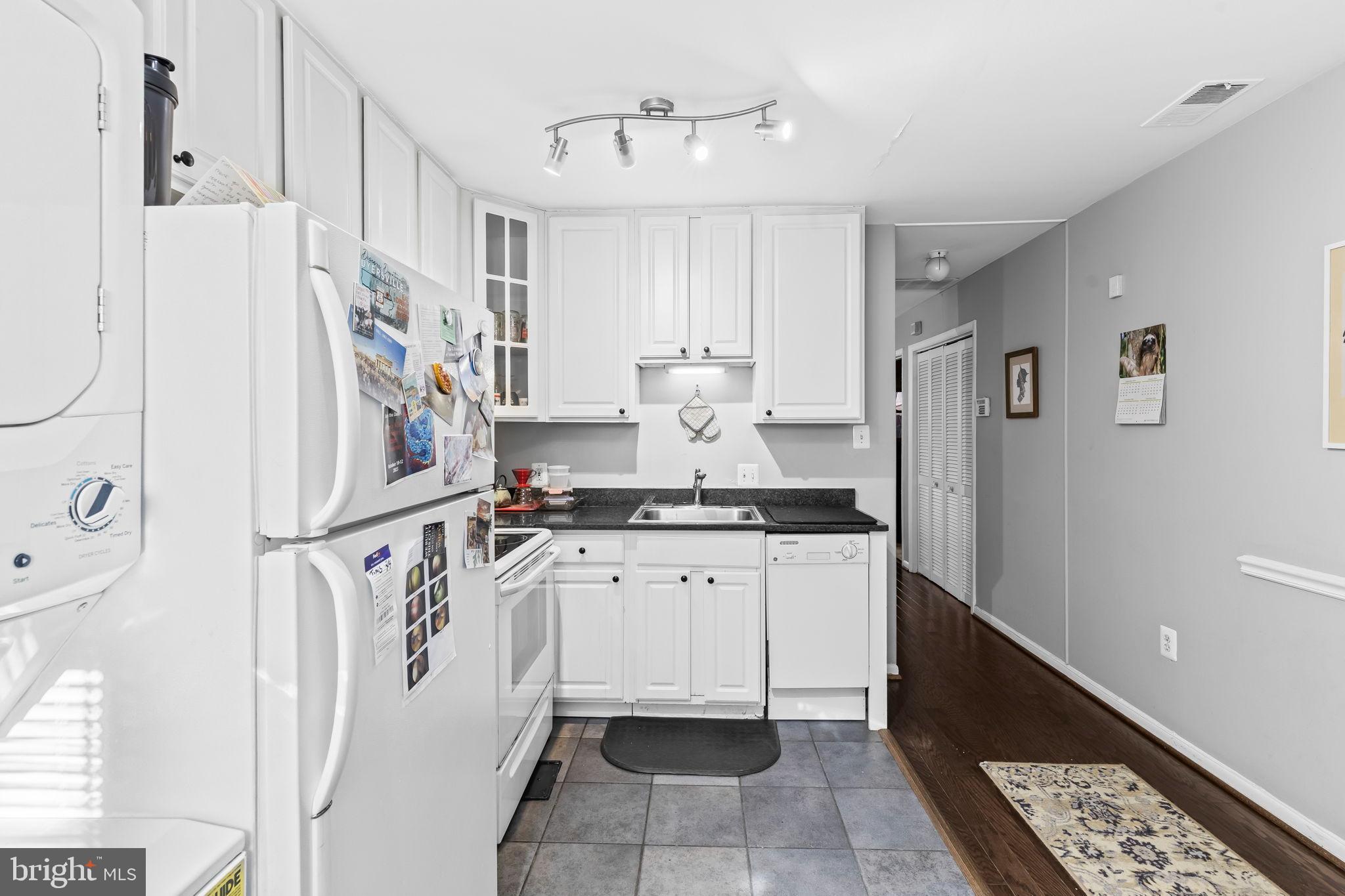 1729 Newton Street Northwest Washington, DC 20010 - Photo 35 of 45 a kitchen with refrigerator and cabinets