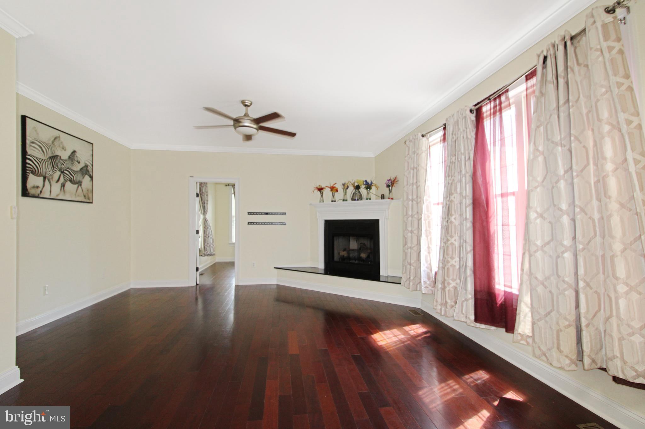 113 Paulowina Road Queen Anne, MD 21657 - Photo 11 of 42 a view of an empty room with a fireplace and a window