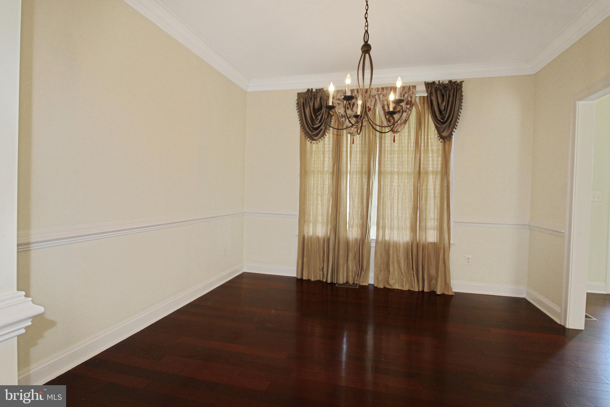 113 Paulowina Road Queen Anne, MD 21657 - Photo 12 of 42 a view of wooden floor and a chandelier in a room