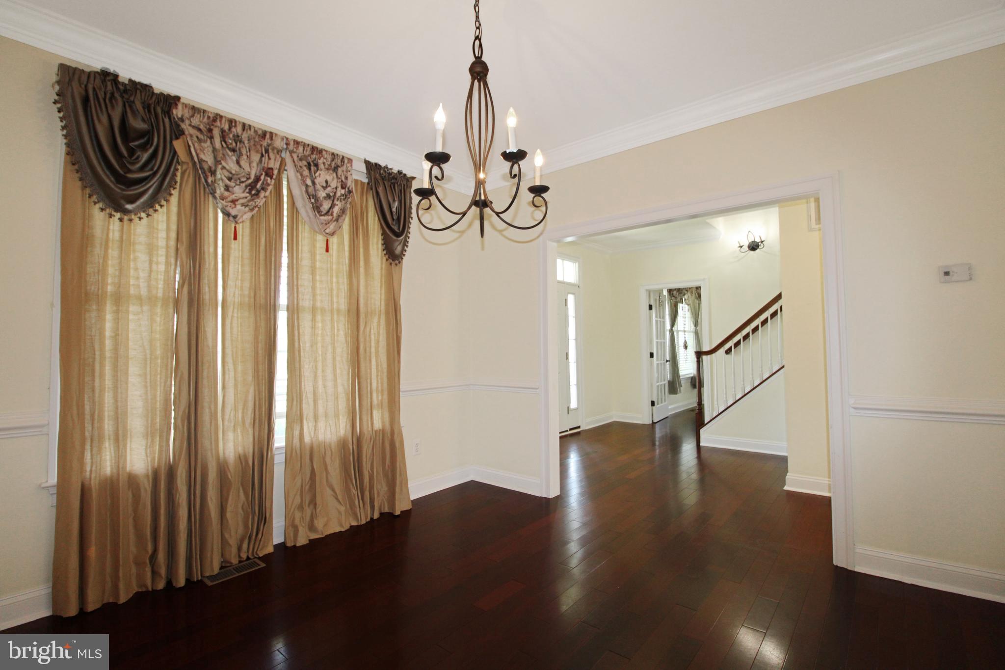 113 Paulowina Road Queen Anne, MD 21657 - Photo 13 of 42 a view of a hallway with wooden floor and stairs