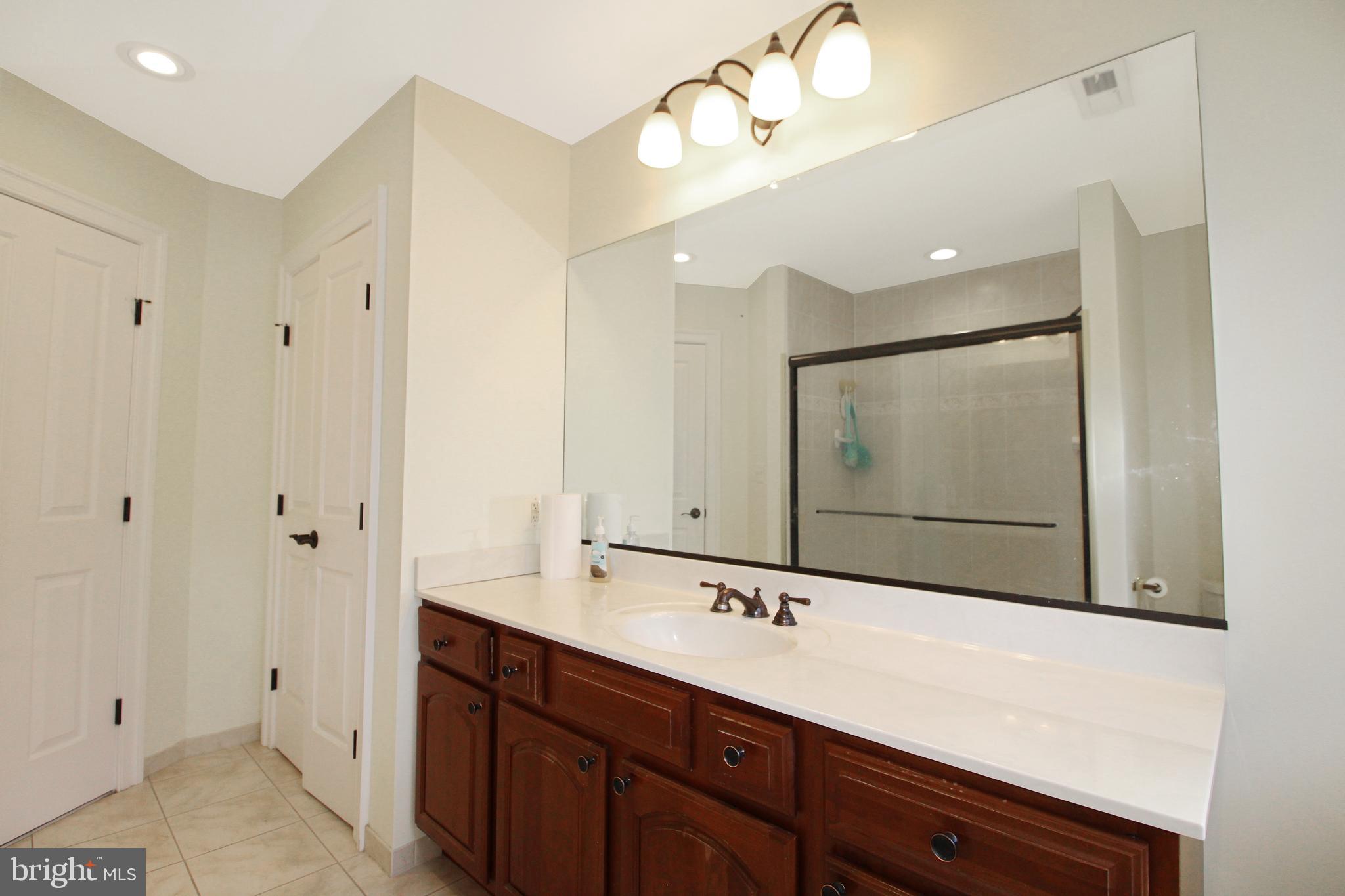 113 Paulowina Road Queen Anne, MD 21657 - Photo 27 of 42 a bathroom with a double vanity sink and a mirror