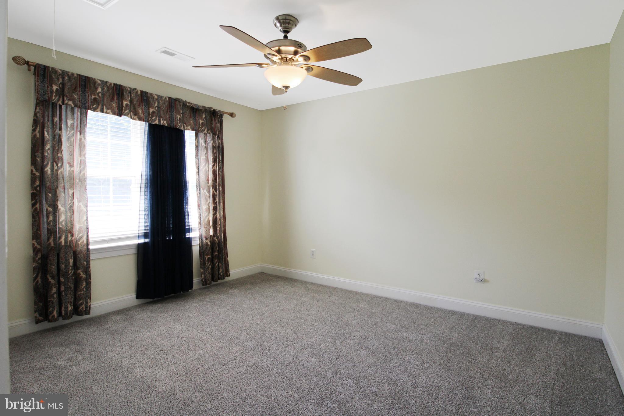 113 Paulowina Road Queen Anne, MD 21657 - Photo 28 of 42 an empty room with windows and fan