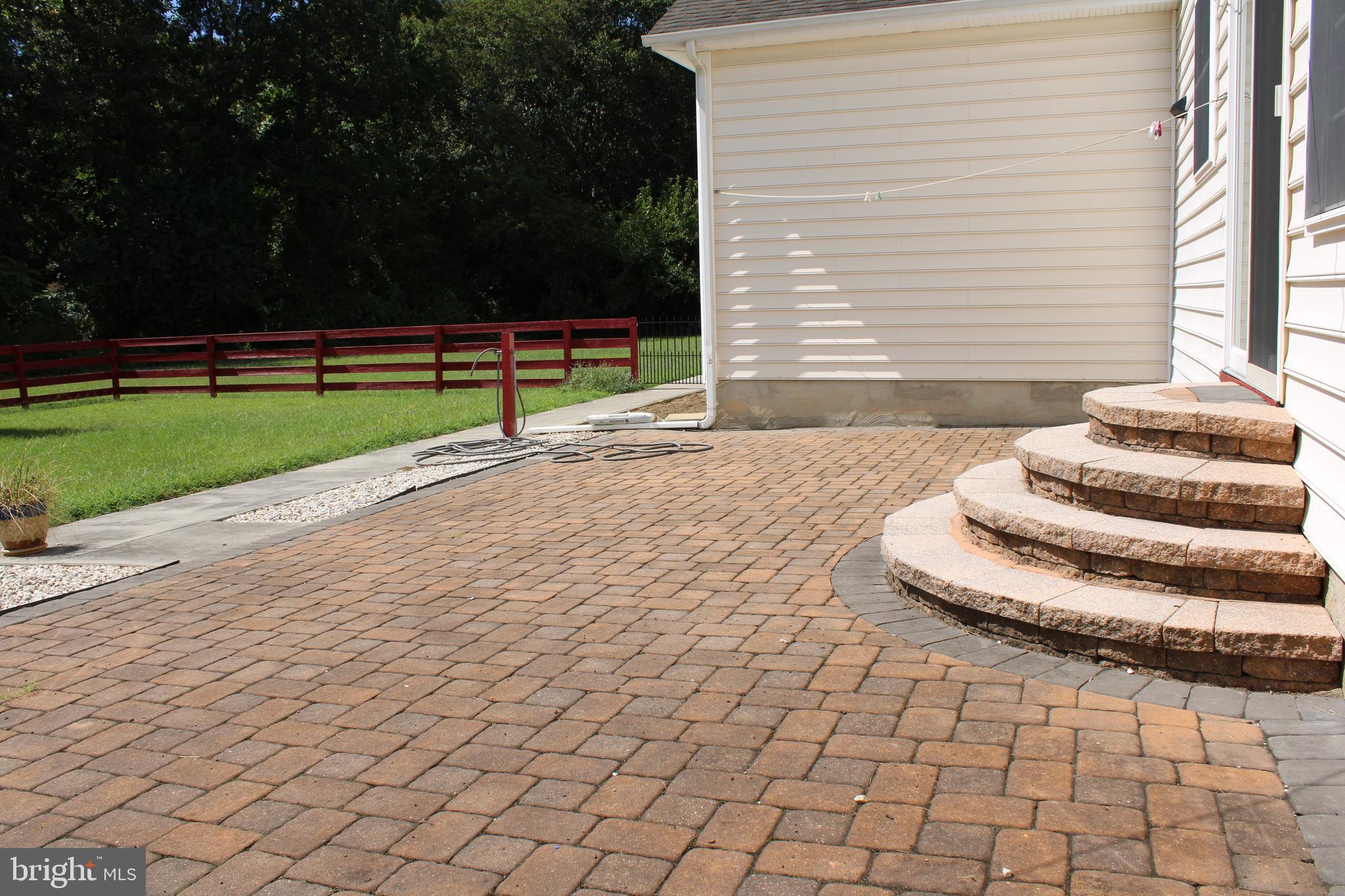 113 Paulowina Road Queen Anne, MD 21657 - Photo 39 of 42 a view of a white house with a yard and a bench