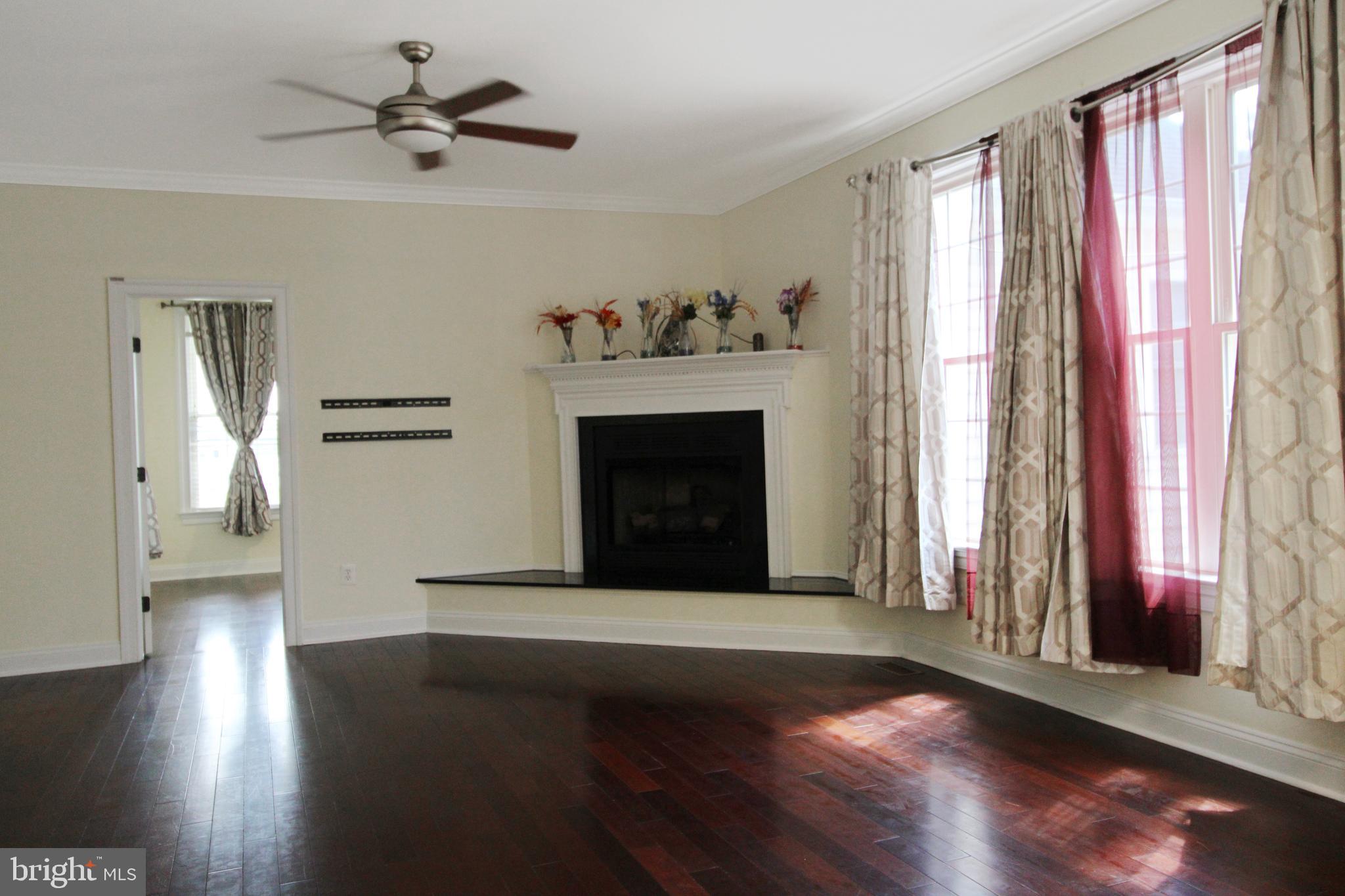 113 Paulowina Road Queen Anne, MD 21657 - Photo 6 of 42 a living room with a fireplace with wooden floor